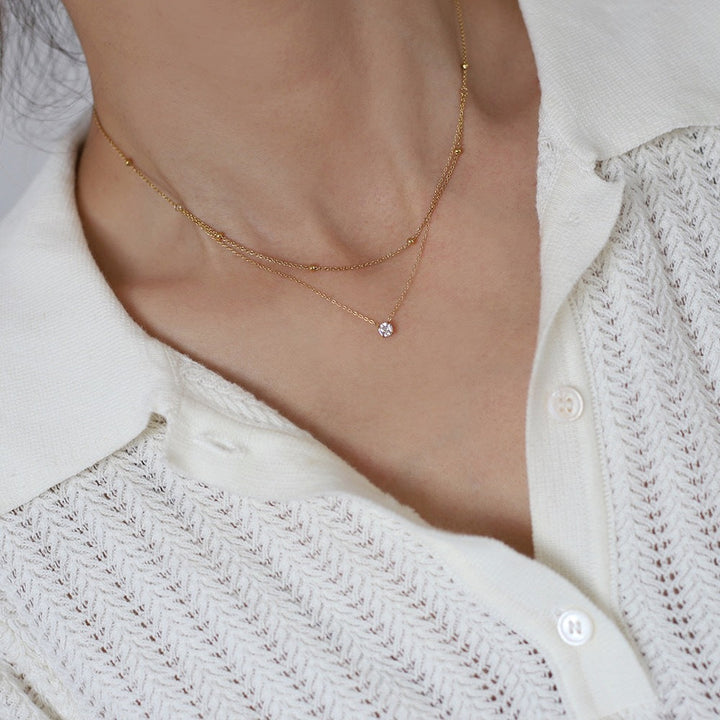 Duet Luxe — Dupla Camada com Pendente Dourado